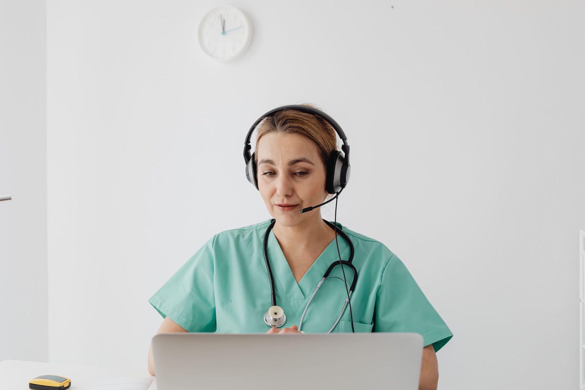A care coordinator with a headset on a check-in call with a patient