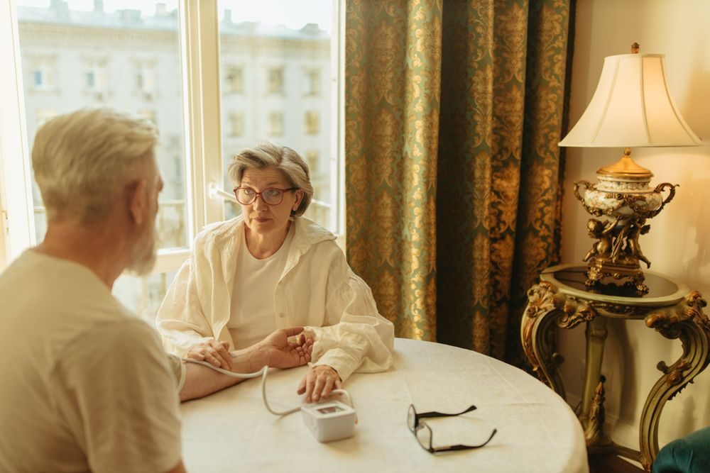 An older couple taking a reading together at home