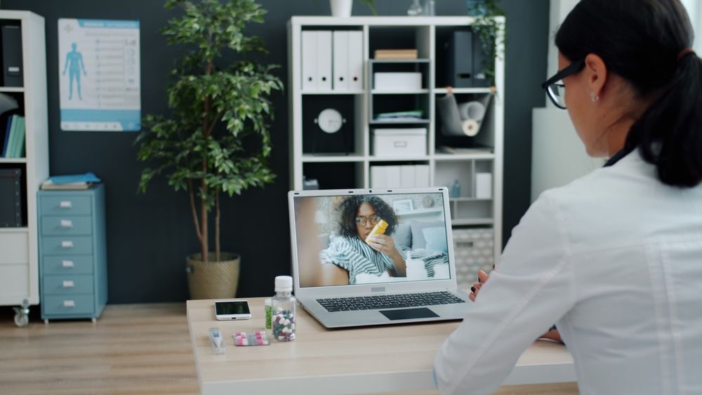 A physician on a video call with a patient