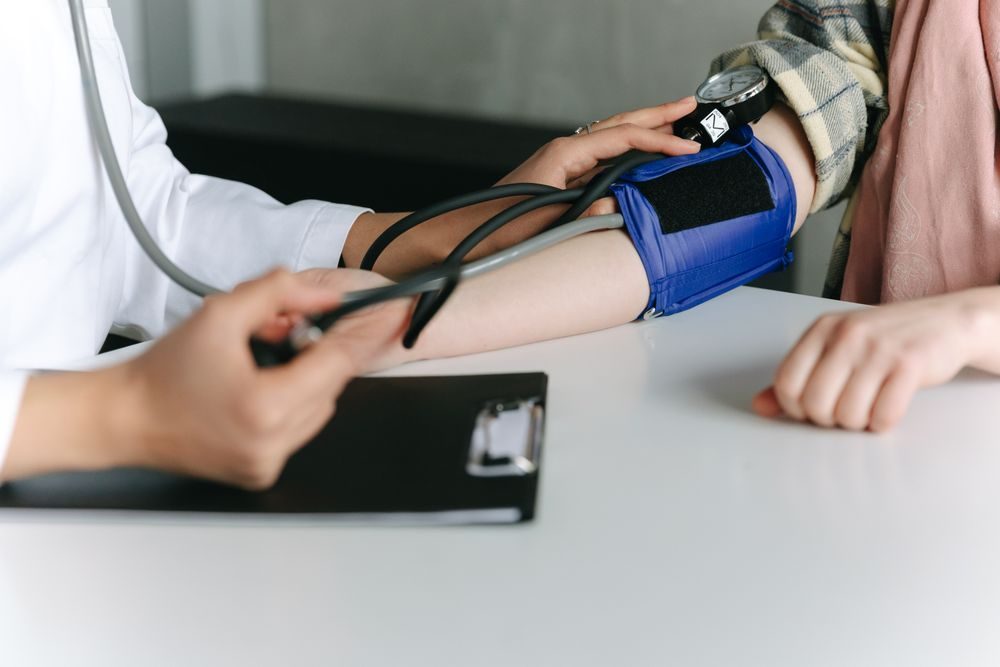 A clinician measuring a patient's blood pressure