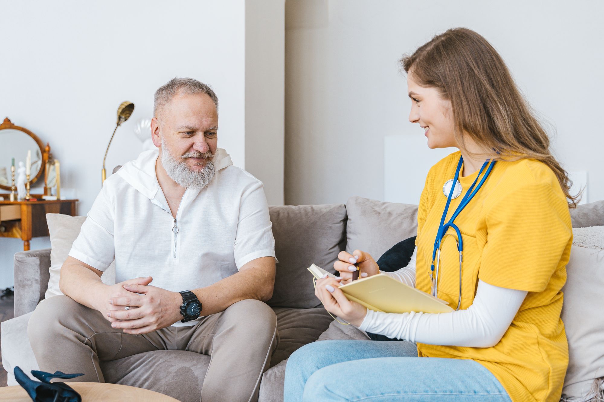 A nurse reviewing a care plan with an older patient at home